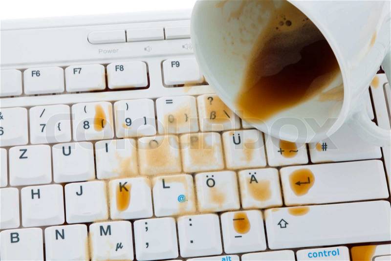 Cup of coffee spilled on a computer keyboard. Damage insurance, stock photo