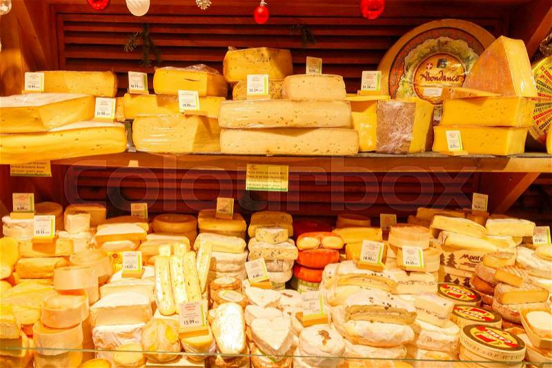 Paris, France - December 22, 2014: French cheese shop with many kinds of cheeses. French cheese is one of the most popular foods in the country, stock photo