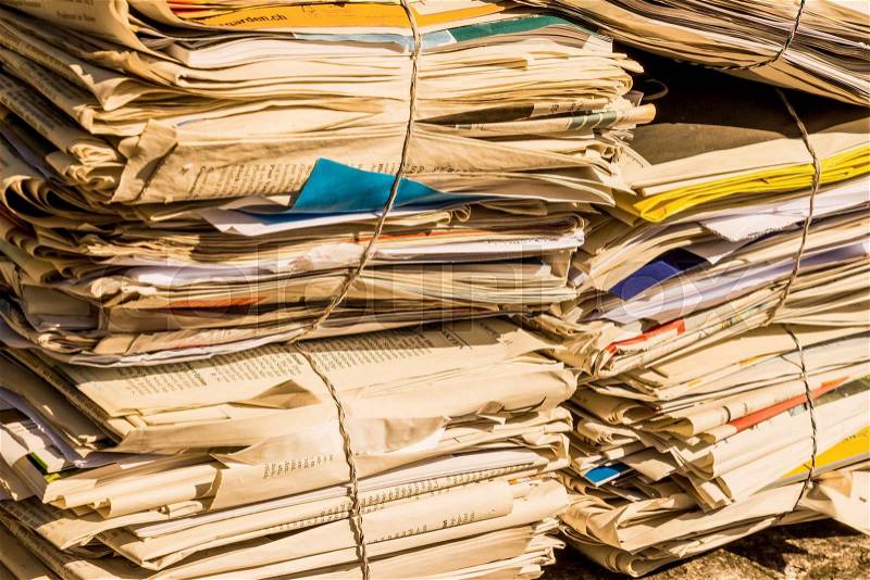 A stack of old newspapers awaiting removal by waste paper disposal, stock photo