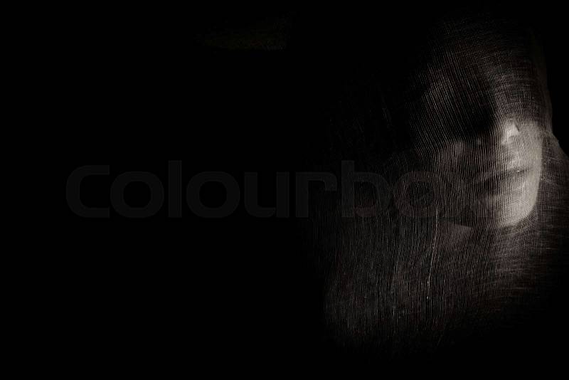 Mystical Face Of The Girl Behind The Textile On Black Background. Black And White Photo. Photo, Picture, stock photo