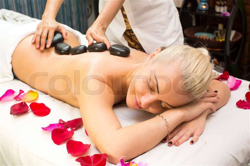 Girl on procedure Balinese massage in the beauty salon, stock photo