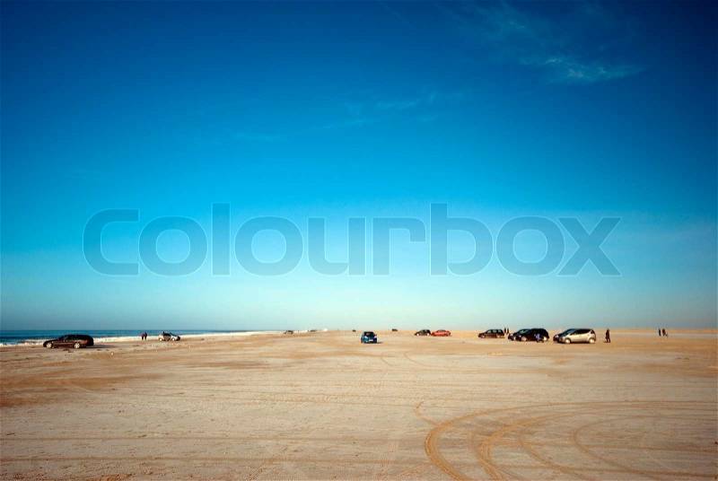 Danish North Sea beach in winter time with cars and people all over, stock photo