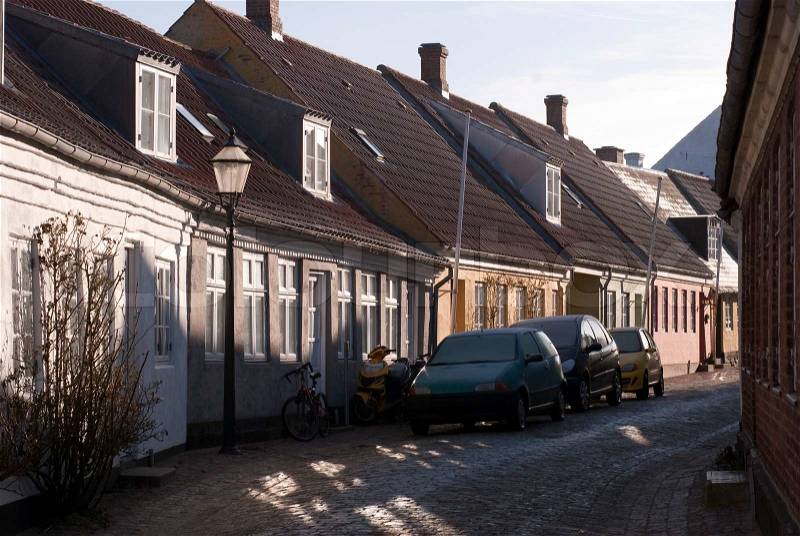 Old street in winter sun from Ribe Town, Denmark. Street name is Groennegade, stock photo