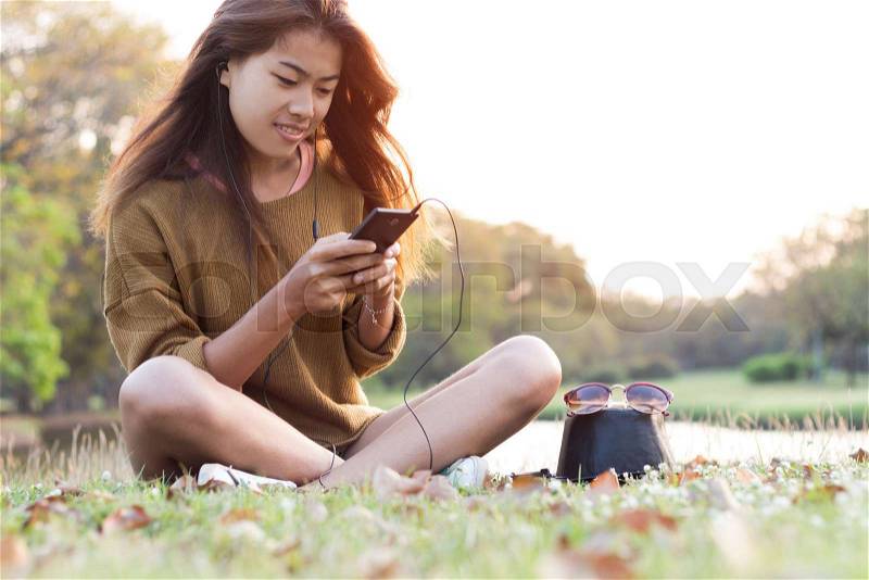 Women feel relax use smart phone mobile at evening, stock photo