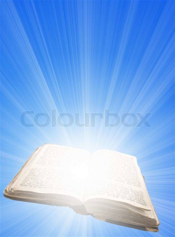 Opened magic book with light, stock photo