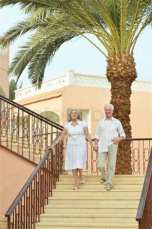 Senior couple have fun at tropic hotel garden, stock photo