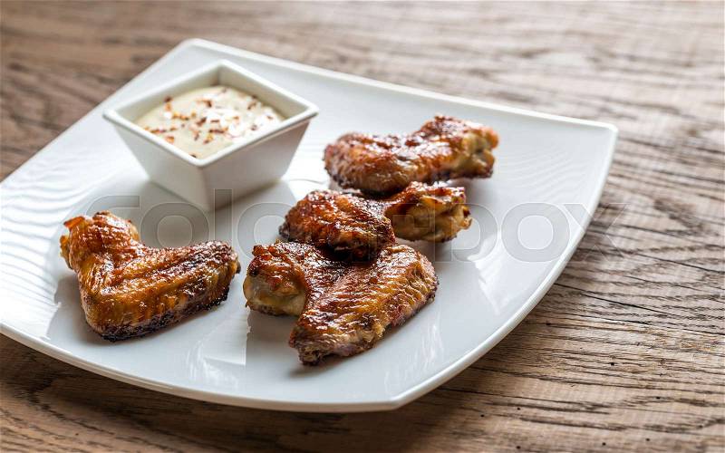 Baked chicken wings with spicy sauce, stock photo