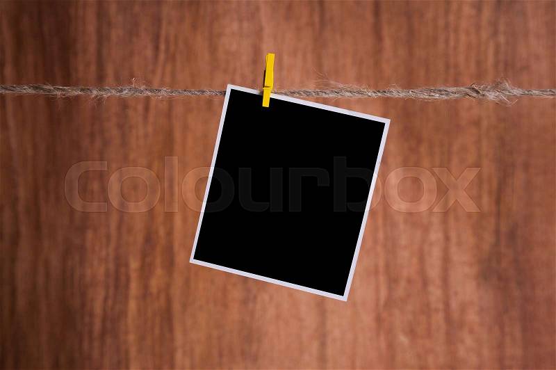 Blank instant photo hanging on the clothesline, stock photo