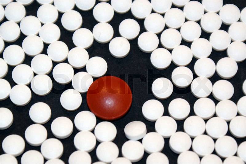 The big red pill and the many white pills, stock photo