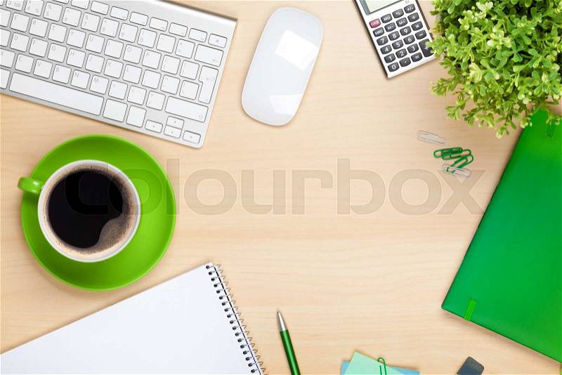 Office table with coffee cup, computer and flower. View from above with copy space, stock photo