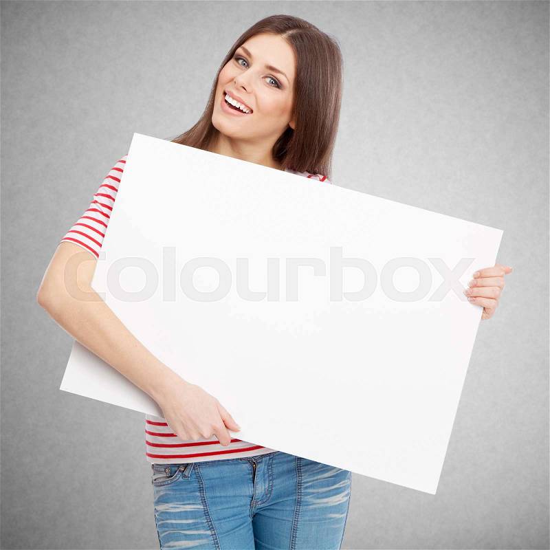 Casual young woman holding a white board, stock photo