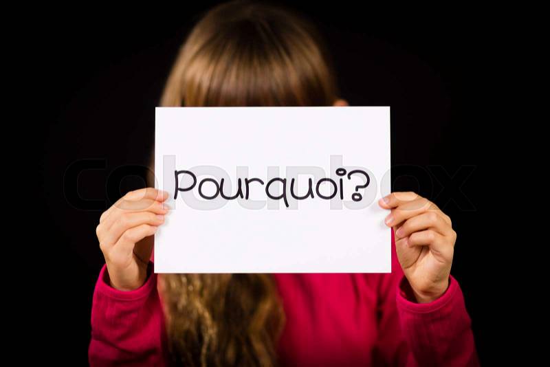 Studio shot of child holding a sign with French word Pourquoi - Why, stock photo