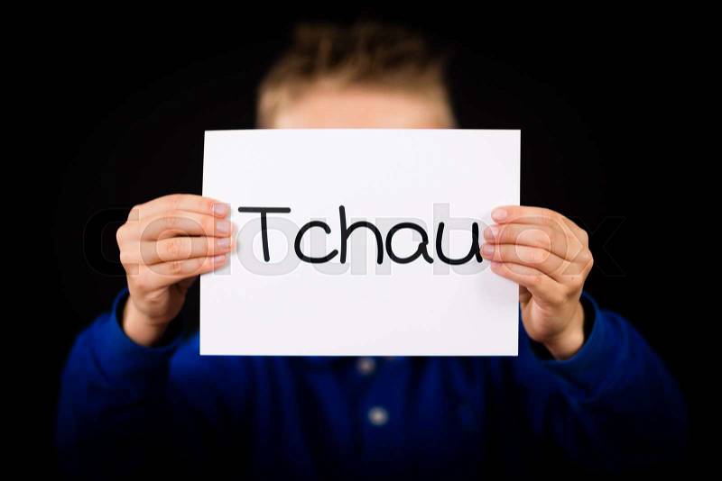 Studio shot of child holding a sign with Portuguese word Tchau - See You Later, stock photo