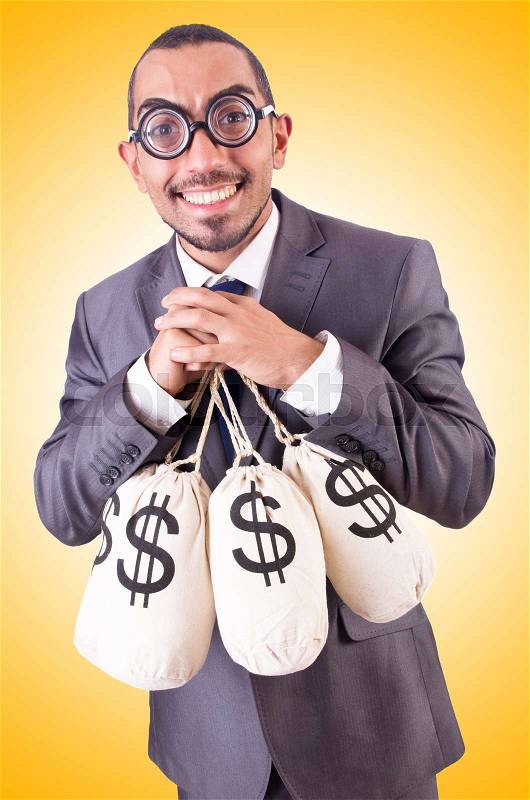Man with sacks of money on white, stock photo