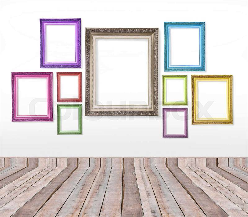 Set of color vintage picture frames on the wall inside the room, stock photo