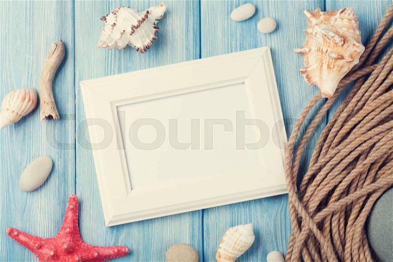 Summer time sea vacation with blank photo frame, star fish and marine rope. Retro toned, stock photo