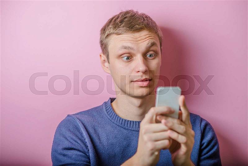 Handsome man looking at phone stun portrait , stock photo