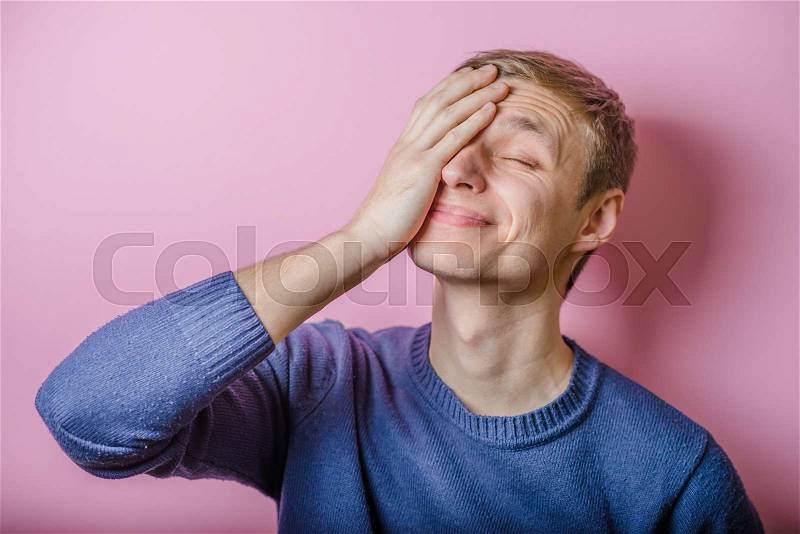 Worried or ashamed man covering his face with hand , stock photo