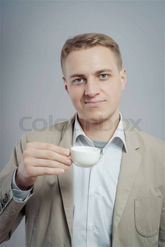 Young Business Man Drinking a Cup of Coffee or Tea, stock photo