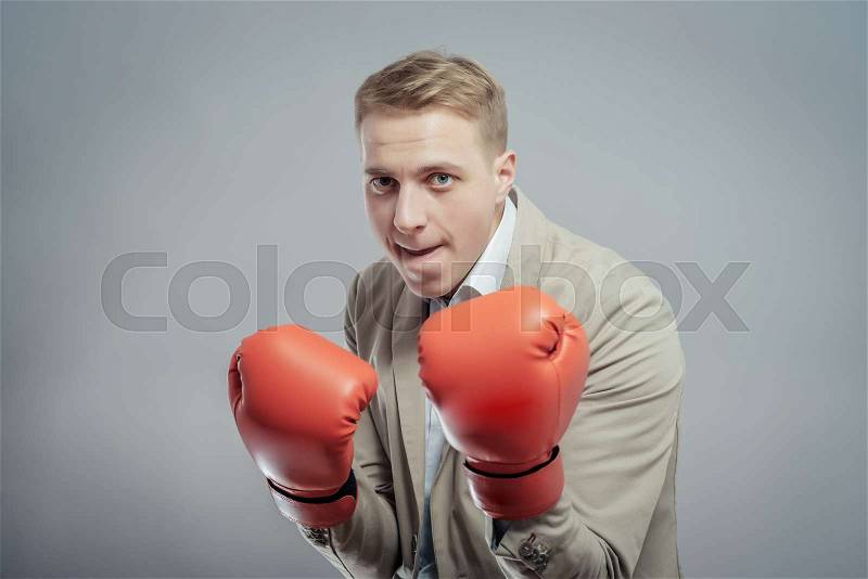 Business man ready to fight with boxing gloves, stock photo