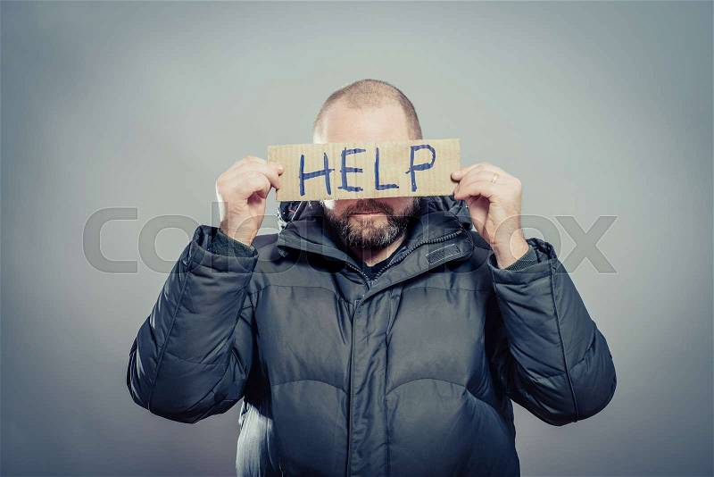 Man holding a cardboard with the text Help, stock photo