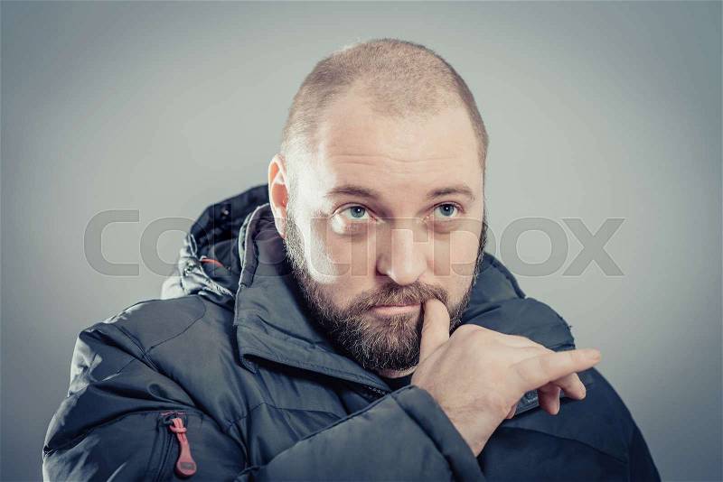 Closeup portrait of a young handsome man biting his finger nails with a craving for something or anxious. Negative human emotion facial expression feeling, stock photo