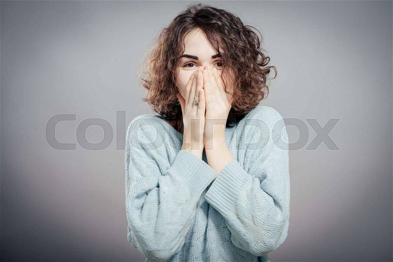 Young woman shocked. Attractive female student in a sweater, stock photo