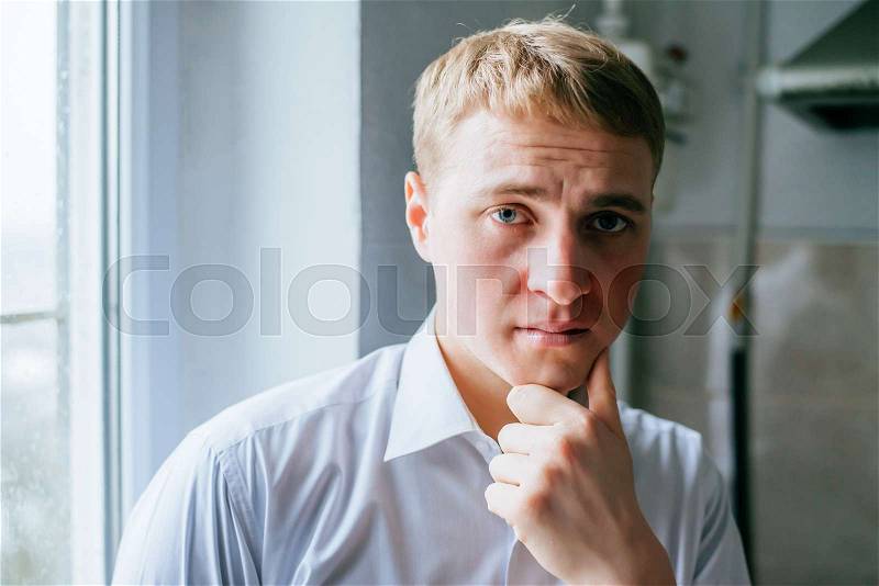 Thinking man . Closeup portrait of a casual young pensive businessman. , stock photo