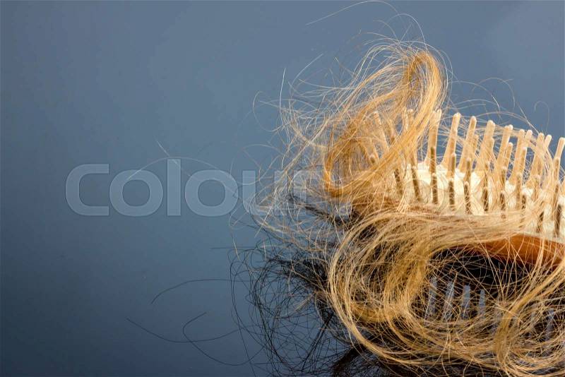 A hair brush with haeren. beginning of hair loss and alopecia, stock photo