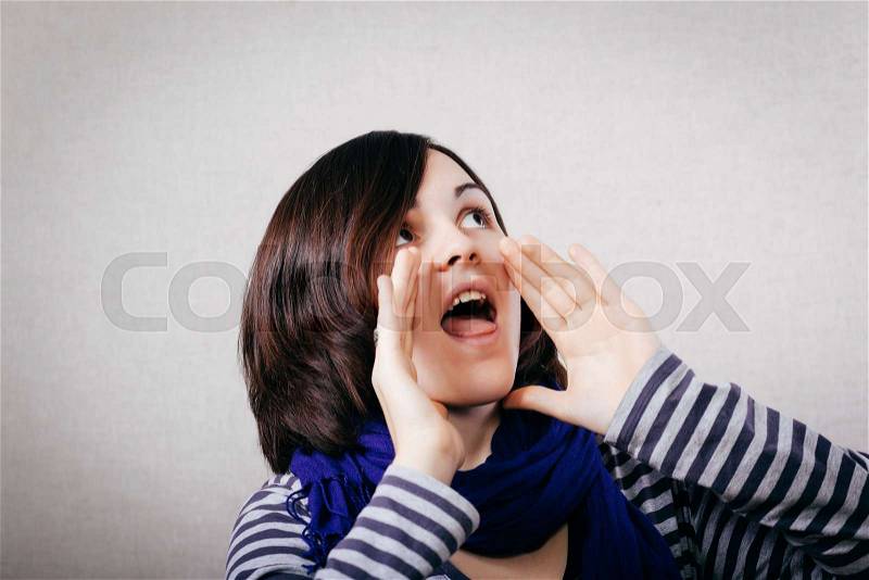 Portrait of pretty young beautiful woman loud screaming or calling out to someone, stock photo