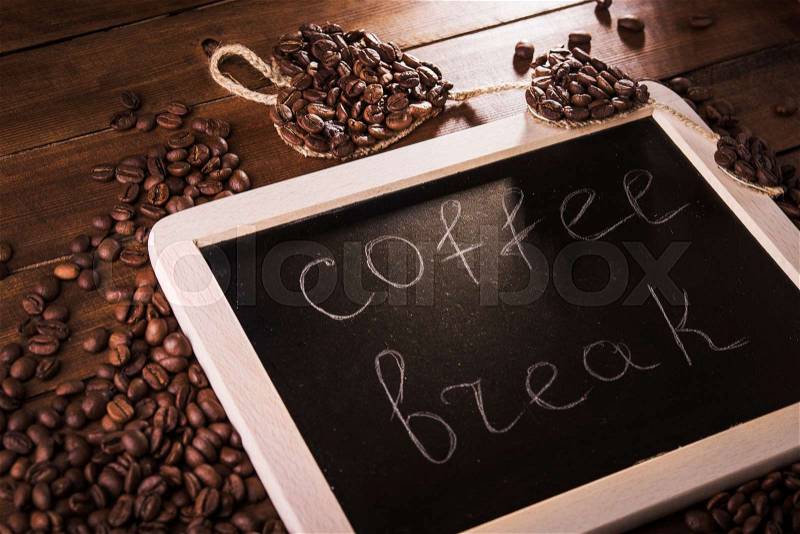 Coffee break board with grains on wood table, stock photo