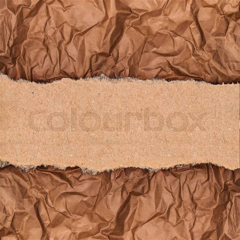 A piece of kraft paper on the background of crumpled paper, stock photo