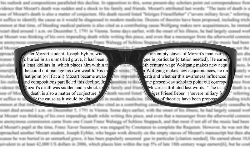 Sight test seen through eye glasses, white background isolated, stock photo
