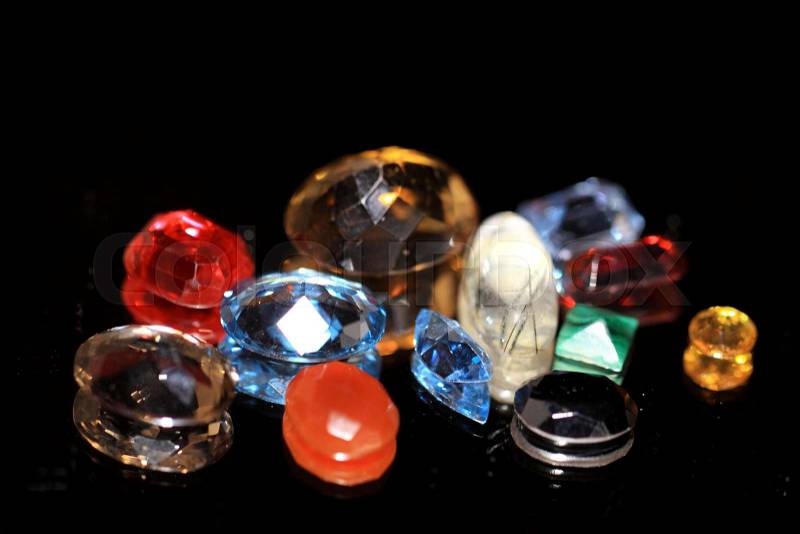 A gemstone or gem. A fine gem, jewel, or a precious or semi-precious stone is a piece of mineral crystal, which, in cut and polished form, stock photo