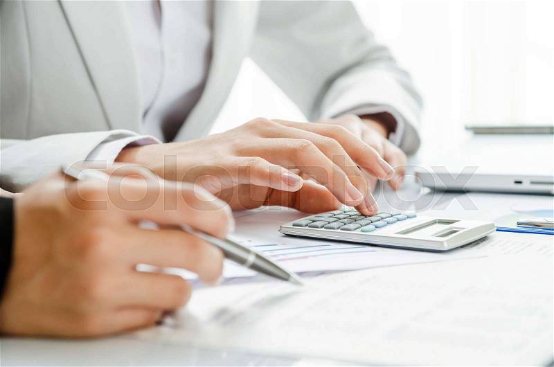 Business persons discussing on financial figures, stock photo
