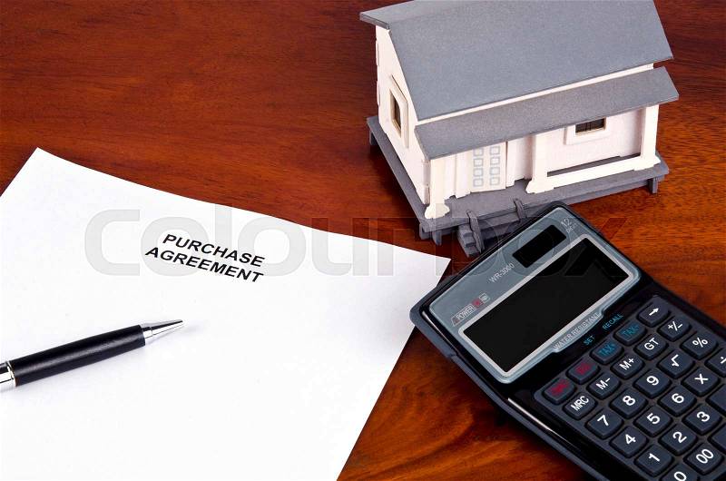 Layout of real estate document, model house and calculator, stock photo