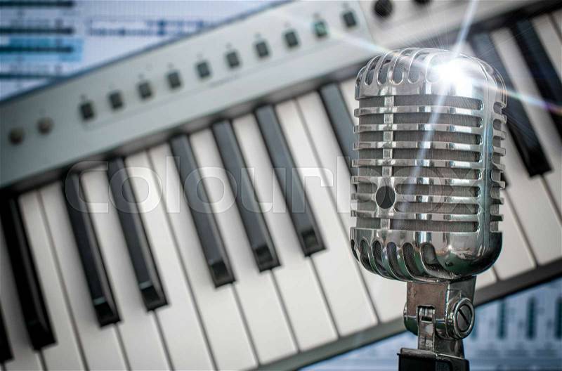 Retro microphone over piano and recording software background, stock photo