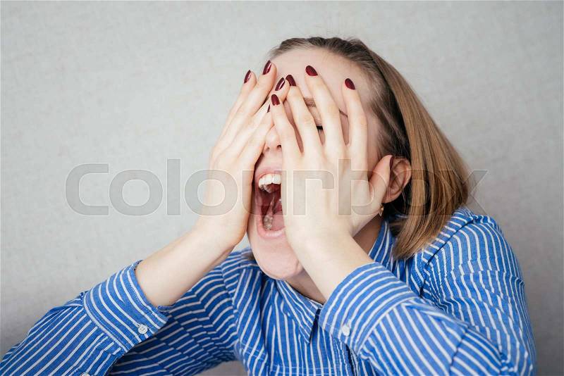 Girl sore eyes and she covers her face with pain, stock photo
