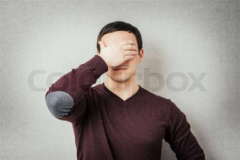 Man covered his face with his hand, stock photo