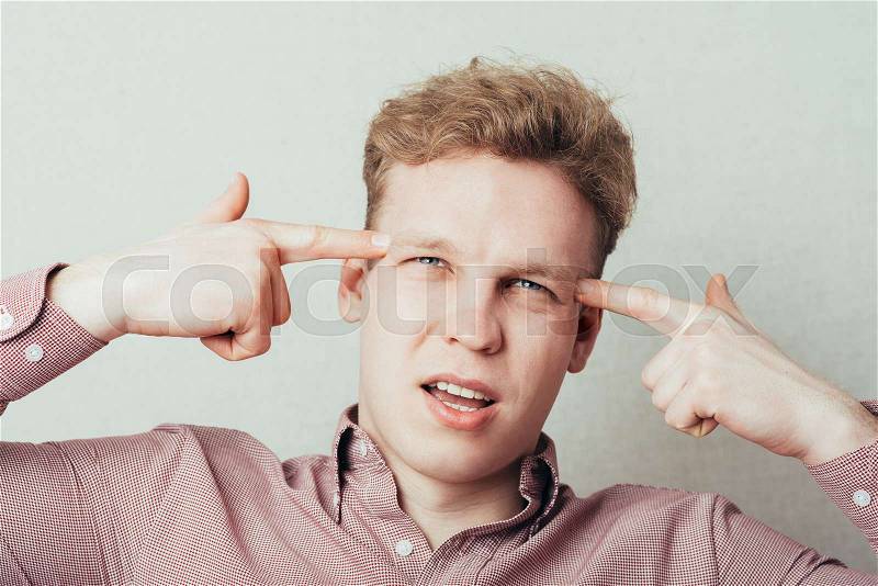 Man thinks and shows on the head with your fingers, stock photo