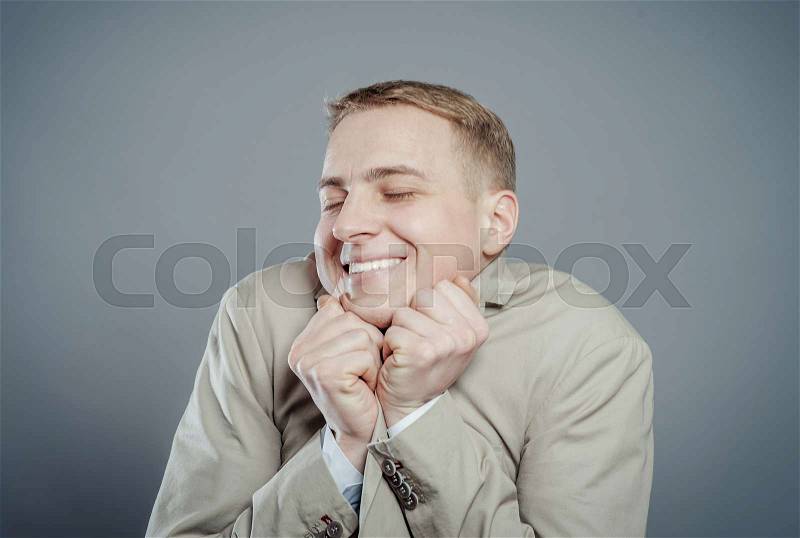 Attractive male head with chin on hands thinking about the cute girl, stock photo
