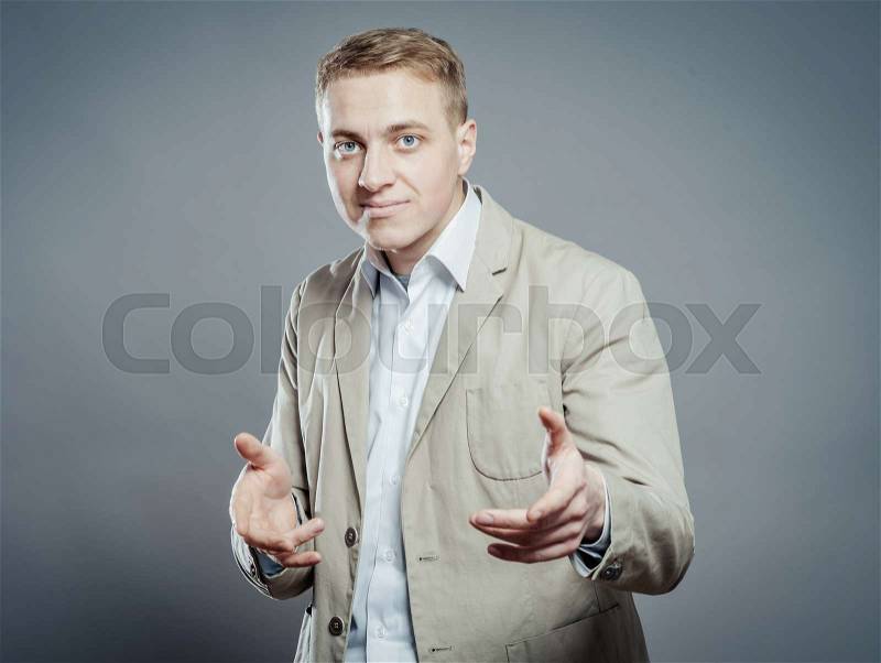 Young man showing something or invitation to come closer, stock photo