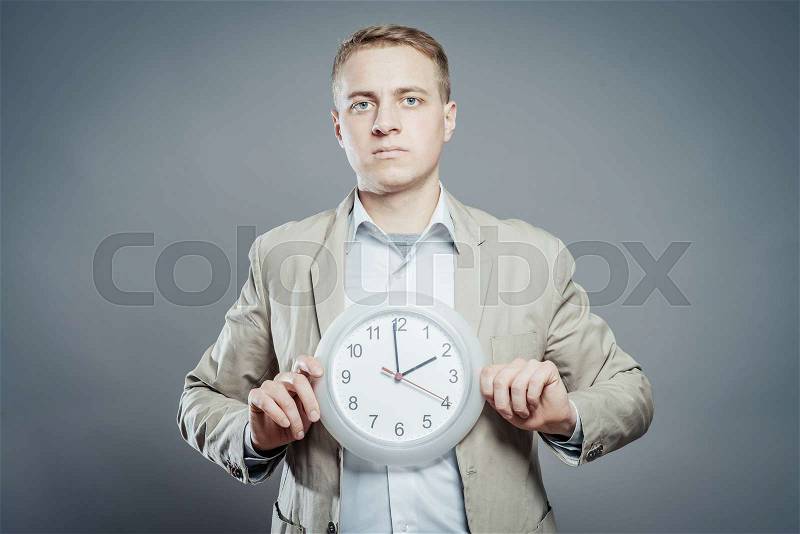 Businessman with clock in time concept, stock photo