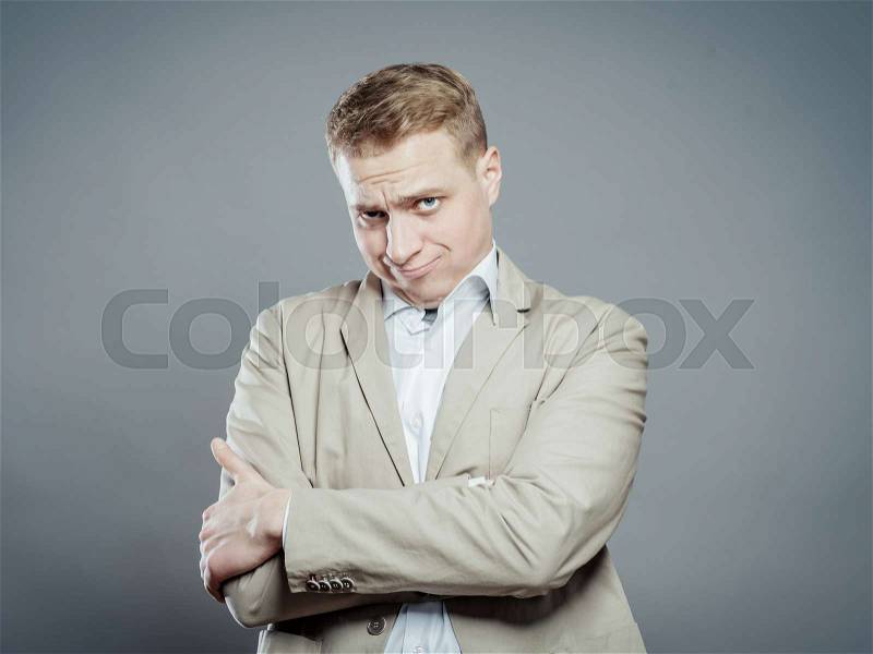 A strong business man distrust looking, and cross hands on his breast, stock photo