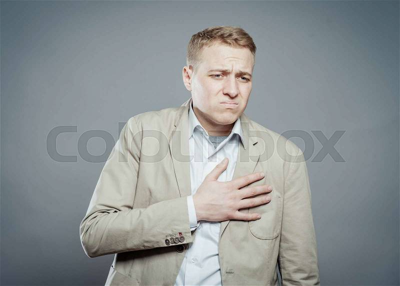 Businessman with hands on his chest. hearts pain, stock photo