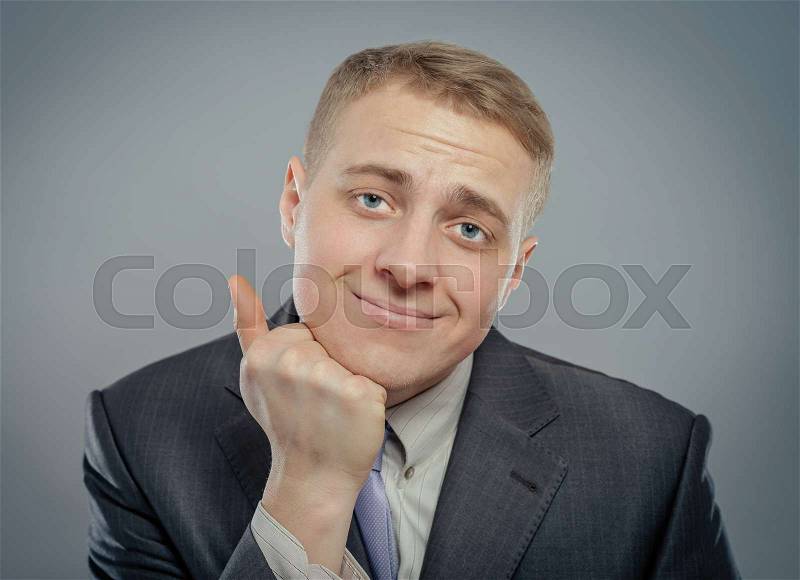 Closeup of a handsome young business man thinking, melancholy, sad, stock photo