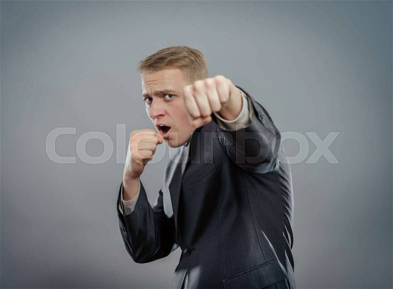 A young man in a suit standing in front boxer, stock photo