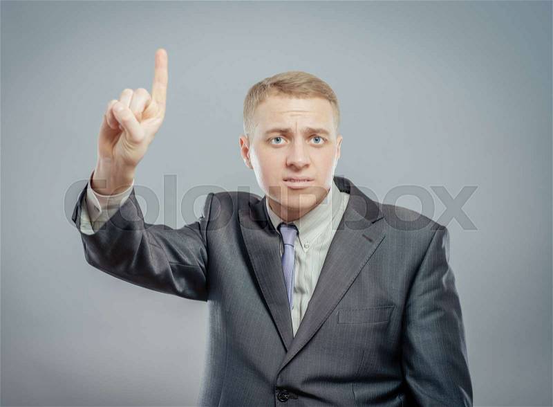 Handsome young business man happy smile point finger up to empty copy space, businessman showing pointing up, concept of advertisement product, wear elegant suit and tie, stock photo
