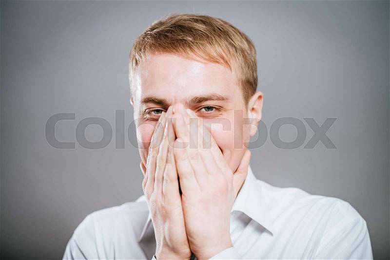 Closeup portrait of laughing excited smiling happy man covering mouth pointing at you with index finger, isolated on white background. Positive human emotion facial expression feeling, body language, stock photo