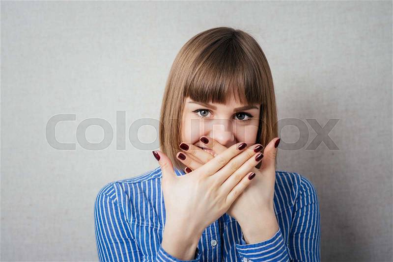 Beautiful young woman covering the face with her hand, stock photo